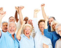 seniors-250x200 Group of happy senior citizens with their hands raised over white